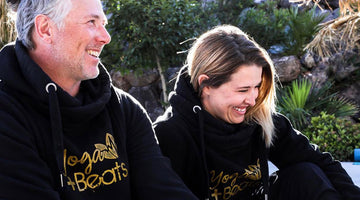 Yvonne with a male friend sitting outside in black hoodies