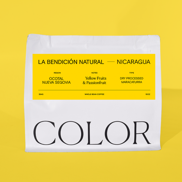 our 10 oz white whole bean coffee bag with yellow label on a yellow background