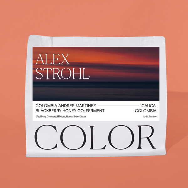A white coffee bag package with a large black and orange landscape-style label reading 'ALEX STROHL' and 'COLOR', shown against a peach background.