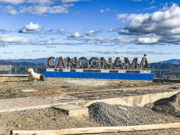 Cangonama Ecuador sign overseeing mountain ranges