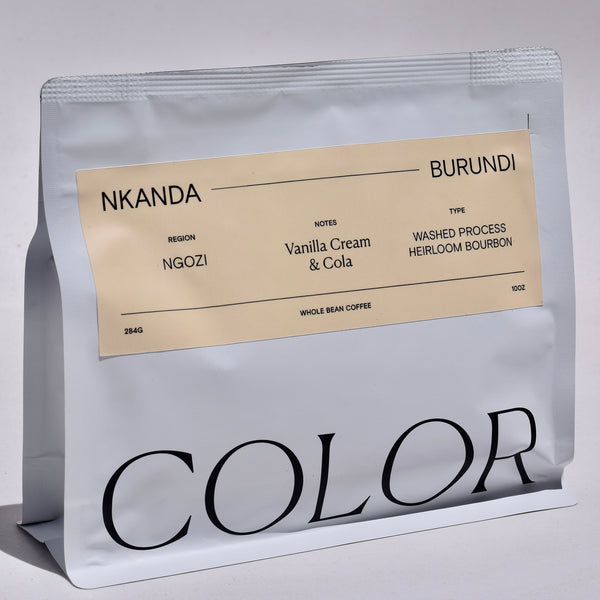 Color Coffee's white 10oz whole bean coffee bag with peach rectangular label and COLOR logo at the bottom