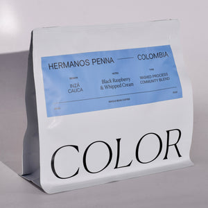 our 10oz white whole bean coffee bag with blue label and COLOR logo at the bottom