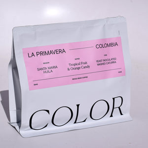 our 10oz white whole bean coffee bag with rectangle pink label and COLOR logo