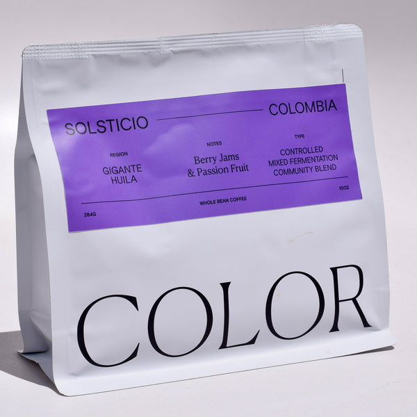 our white 10oz whole bean coffee bag with purple label and COLOR logo at the bottom