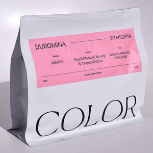 our 10oz white whole bean coffee bag with pink label for our newest Ethiopia Duromina coffee with COLOR logo at the bottom