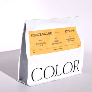 our white 10oz whole bean coffee bag with orange label and COLOR logo