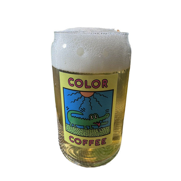 Can glass with a crocodile and sun illustration and the words color coffee