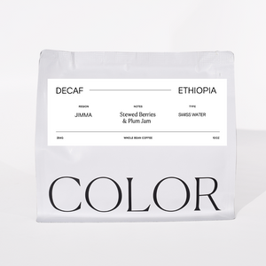 our white 10oz whole bean coffee bag with white label and COLOR logo at the bottom on a white background