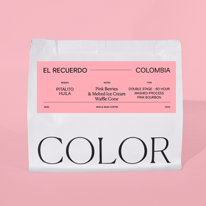 Coffee package labeled 'El Recuerdo Colombia' with a pink label on a pink background