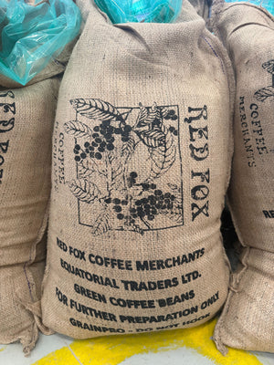 Burlap coffee bags with branding and text on a light background