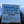 Load image into Gallery viewer, Ibonia Estate sign with contact information and management details against a blue sky.
