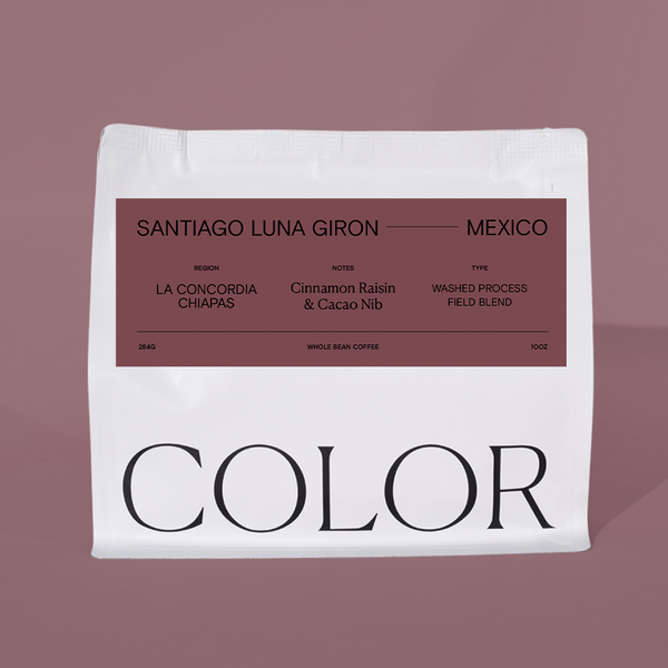 A white bag of COLOR coffee with a dusty rose label, set against a matching dusty rose background. The label reads 'SANTIAGO LUNA GIRON - MEXICO' and lists La Concordia Chiapas, Cinnamon Raisin & CacaoNib, as a washed process field blend.