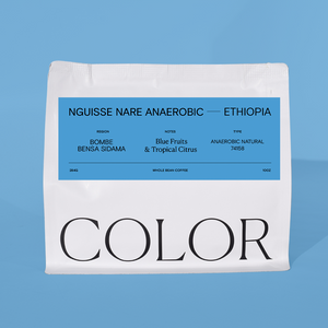 our 10oz white whole bean coffee bag with blue label and COLOR logo on a blue background