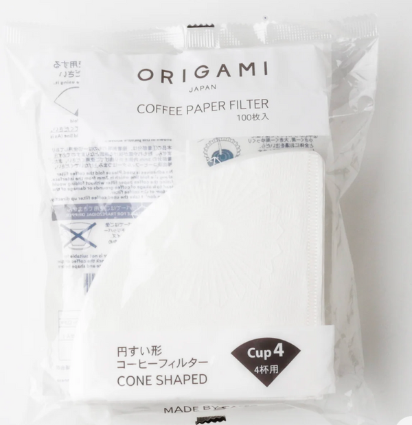 A package of Origami Japan cone-shaped coffee paper filters, 100 count, in a clear plastic bag with white paper inserts visible inside.