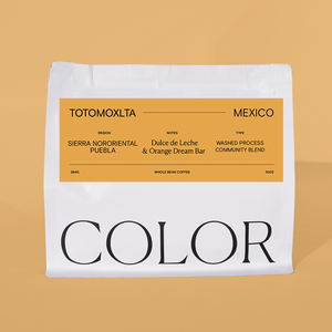 our white 10oz whole bean coffee with orange label and COLOR logo at the bottom on an orange background