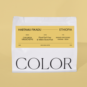 our 10oz white whole bean coffee with yellow label and COLOR logo on a yellow background