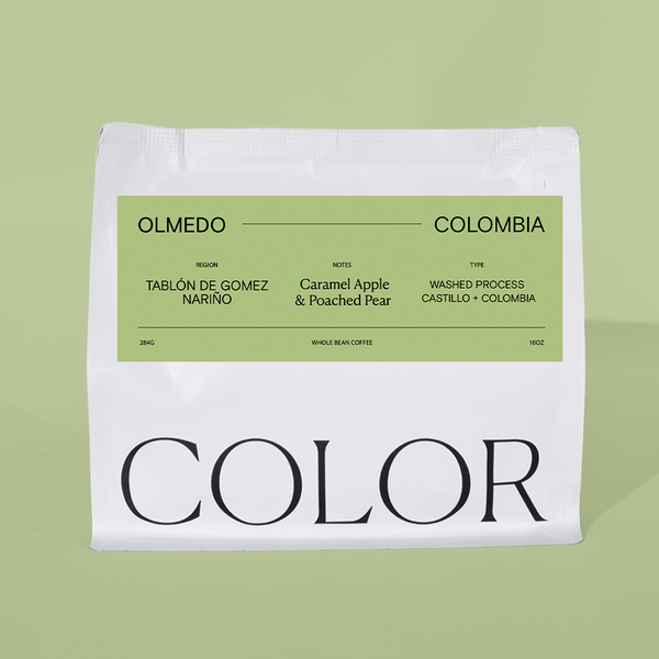 our white 10oz whole bean coffee bag with green label and COLOR logo at the bottom on a green background.