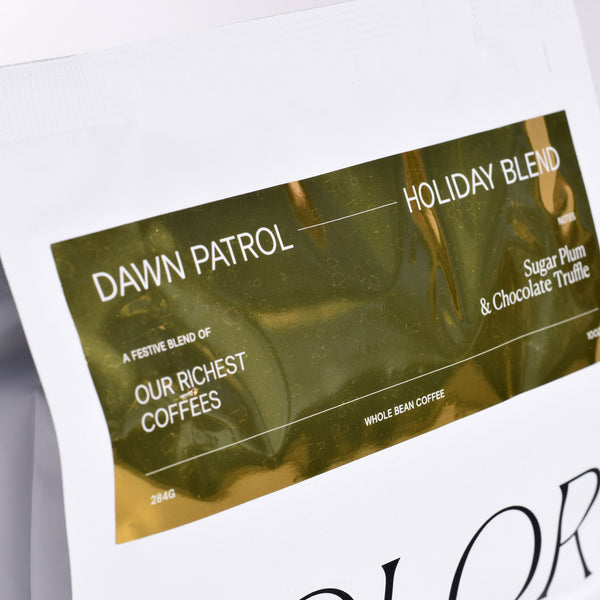 zoom in of holiday blend dawn patrol in our new 10oz white bag with gold label
